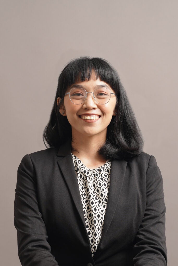 Headshot of Husna Ukrina in a brown background
