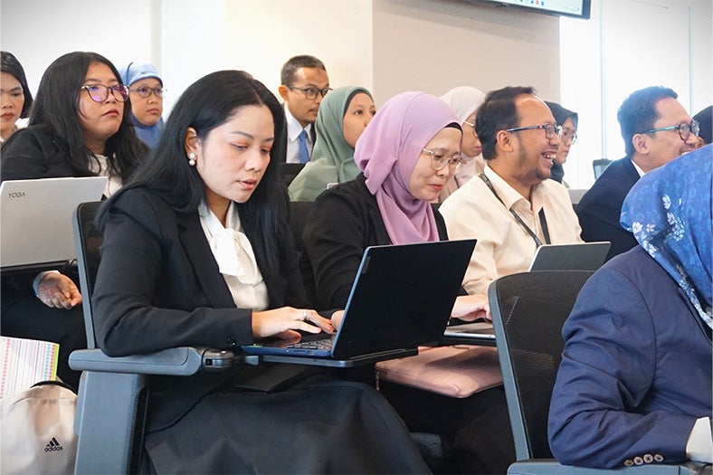 students using laptops in a classroom