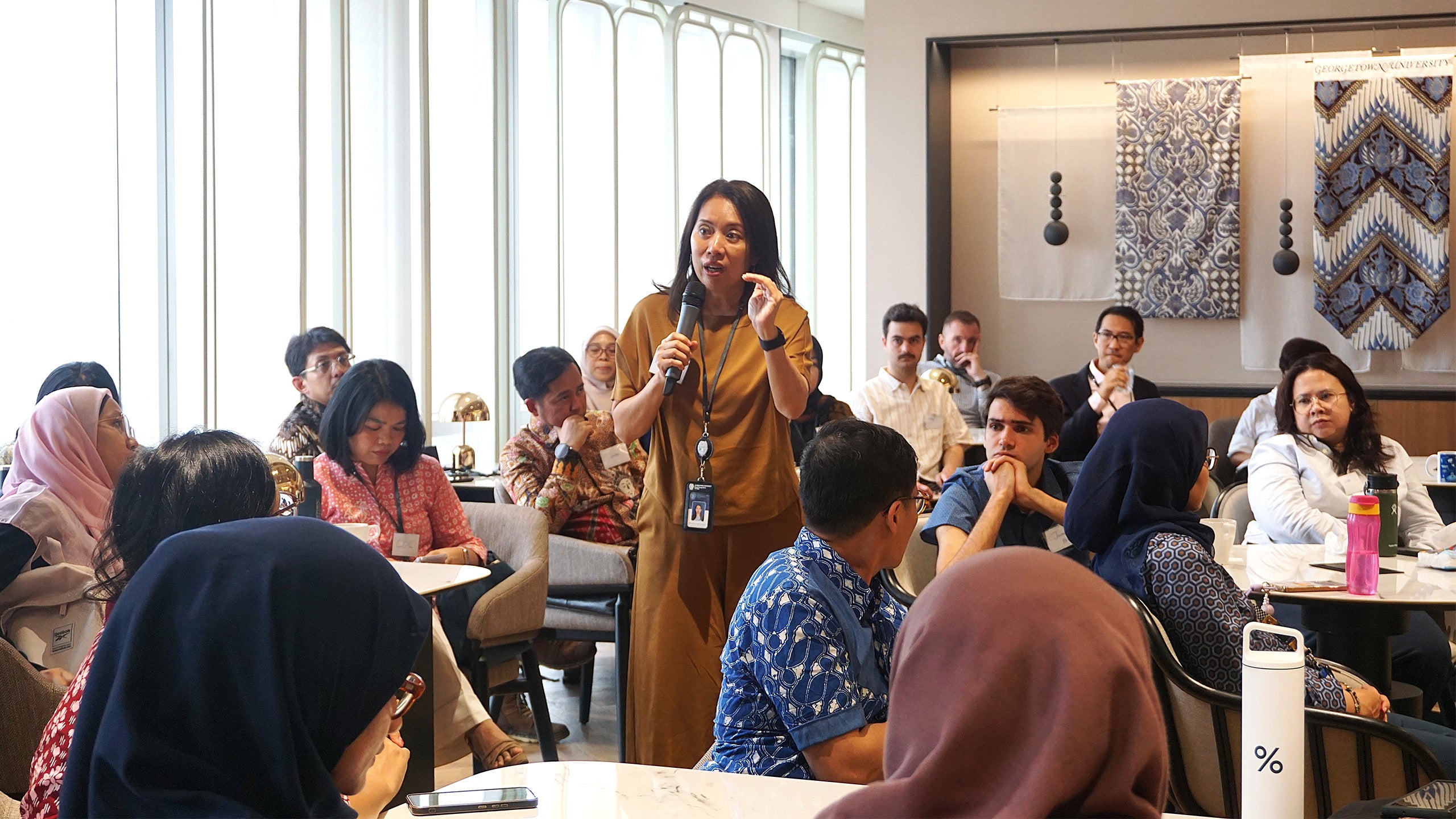 A woman giving a presentation to guests in a room