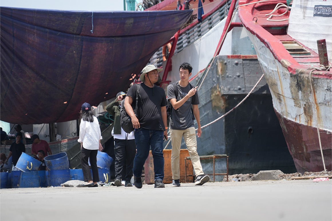 Students talking at a construction site