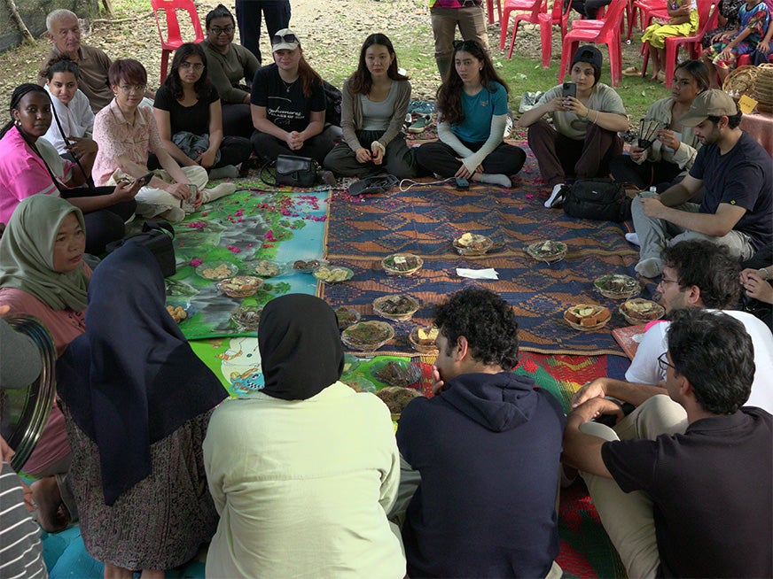 Students sitting in a circle enjoying a picnic