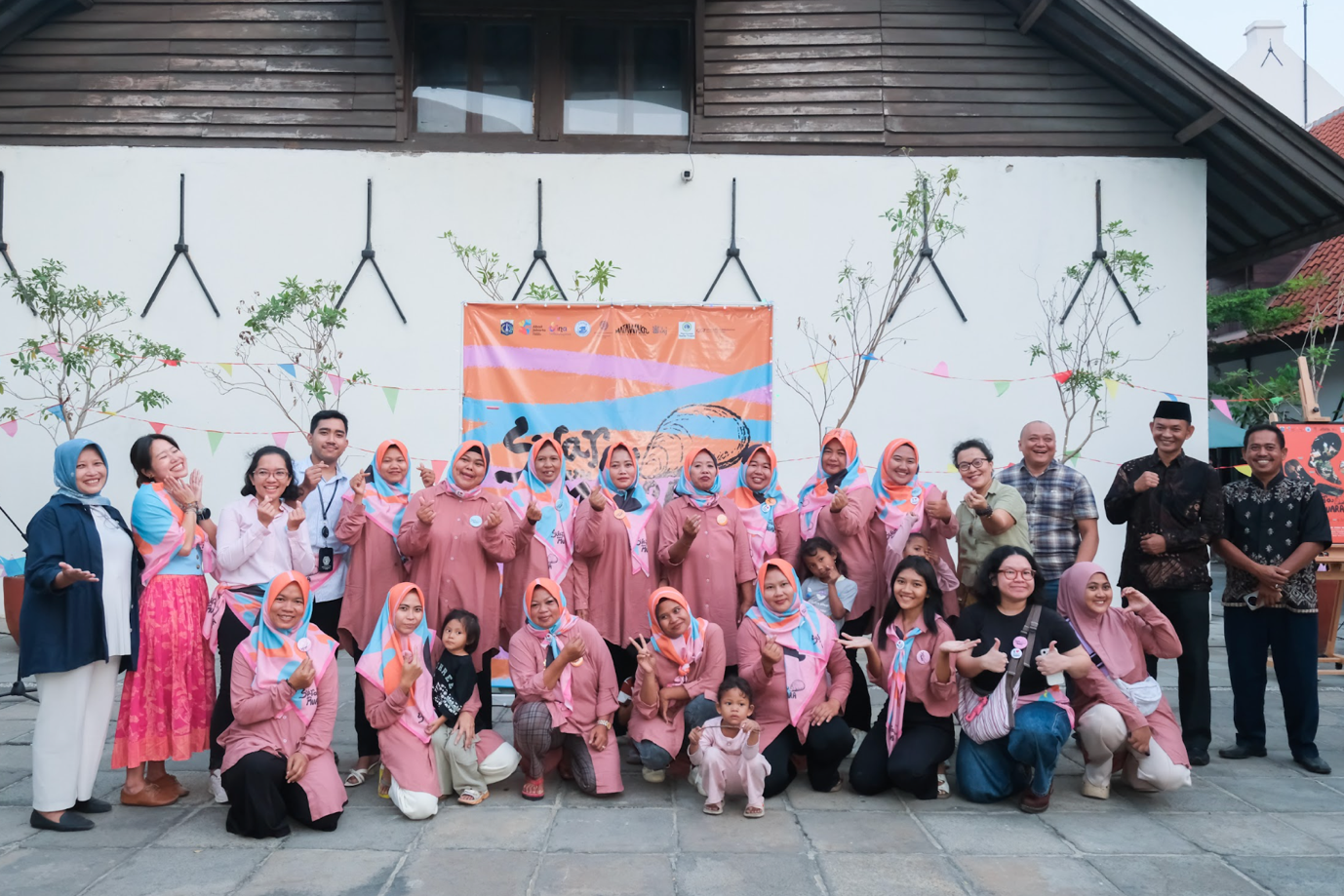 Women of Muara Angke, and collaborators gather for a group photo during the opening of the Suara dari Muara exhibition.